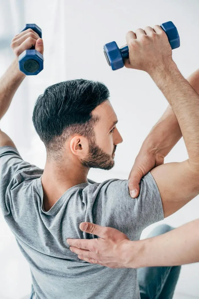 Patient doing shoulder strengthening with therapist support